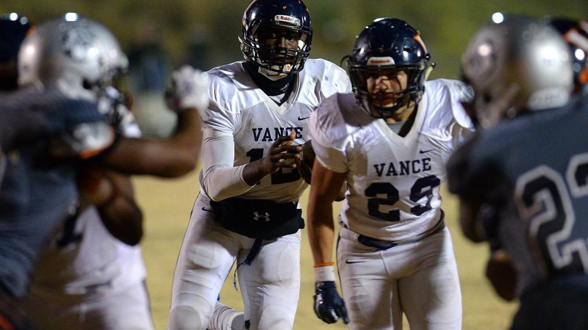 Vance Cougars quarterback Kingsley Ifedi rolls out to the left following running back Kalen Clark who will provide the block allowing Ifedi to run into the end zone for the game winning two-point conversion over the Butler Bulldogs at Butler High School on Friday, December 2, 2016. Final score Vance 50, Butler 49.