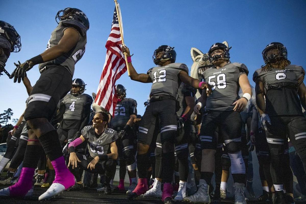 Hough High quarterback Kennique Bonner-Steward(12) leads the Huskies out to face North Meck on Friday.