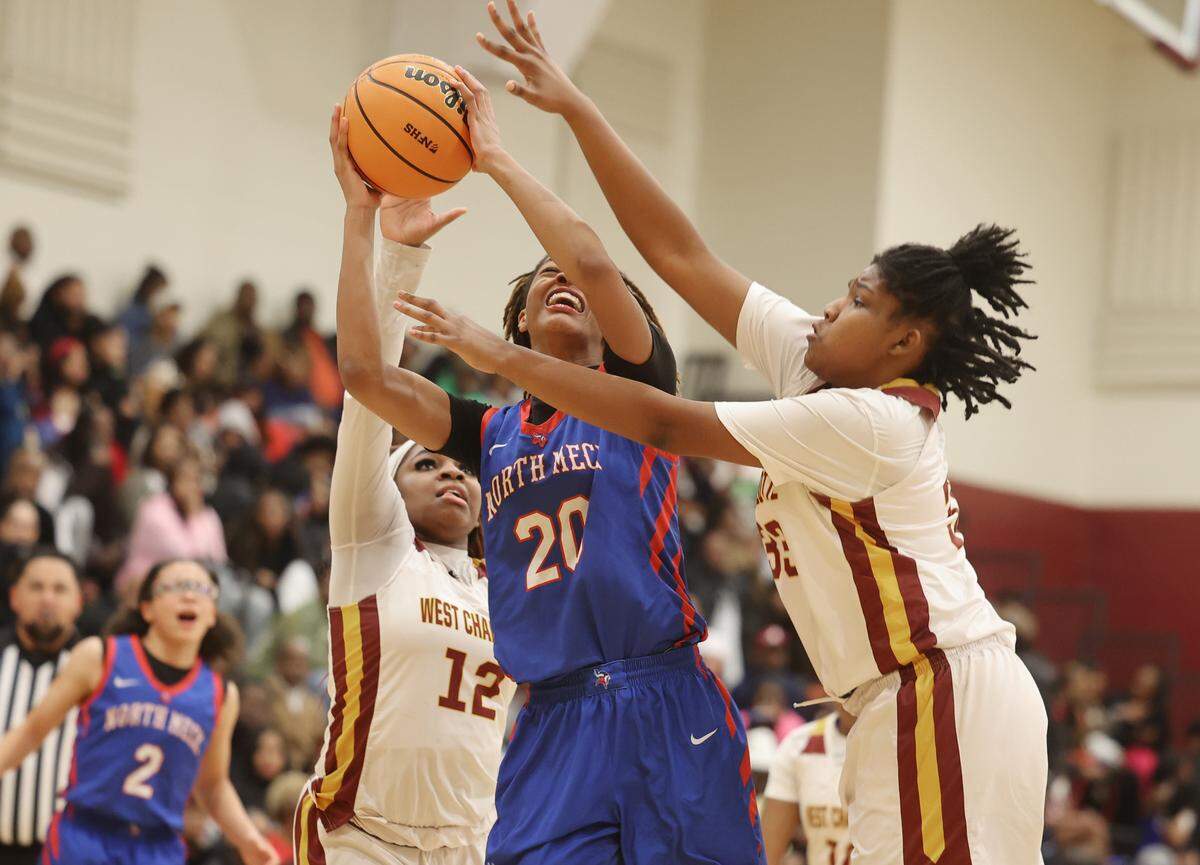 North Mecklenburg High School small forward Autumn Lacy takes the shot against West Charlotte guard Paris Reaves (12) and forward Savonna Grimes, right, on Thursday, Jan. 29, 2026 at West Charlotte High School.