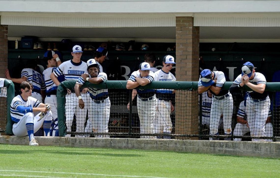 Charlotte Christian baseball players watch in dejection as Wesleyan Christian Academy baseball players celebrate winning over Charlotte Christian in the NCISAA 3A state championship baseball game at Charlotte Country Day Saturday afternoon.