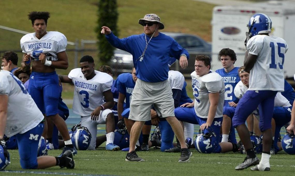 Mooresville High football coach Marty Paxton leads practice Monday afternoon at the school. The Blue Devils will play host to Hopewell on Friday.