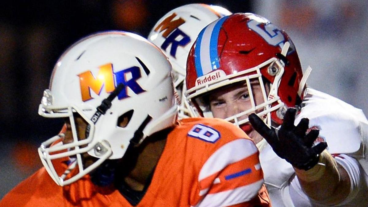 Charlotte Catholic defensive end Kevin Coss, right, helped lead the Cougars to a 2017 state 3A championship. He’s a member of the Charlotte Observer All-Mecklenburg defense