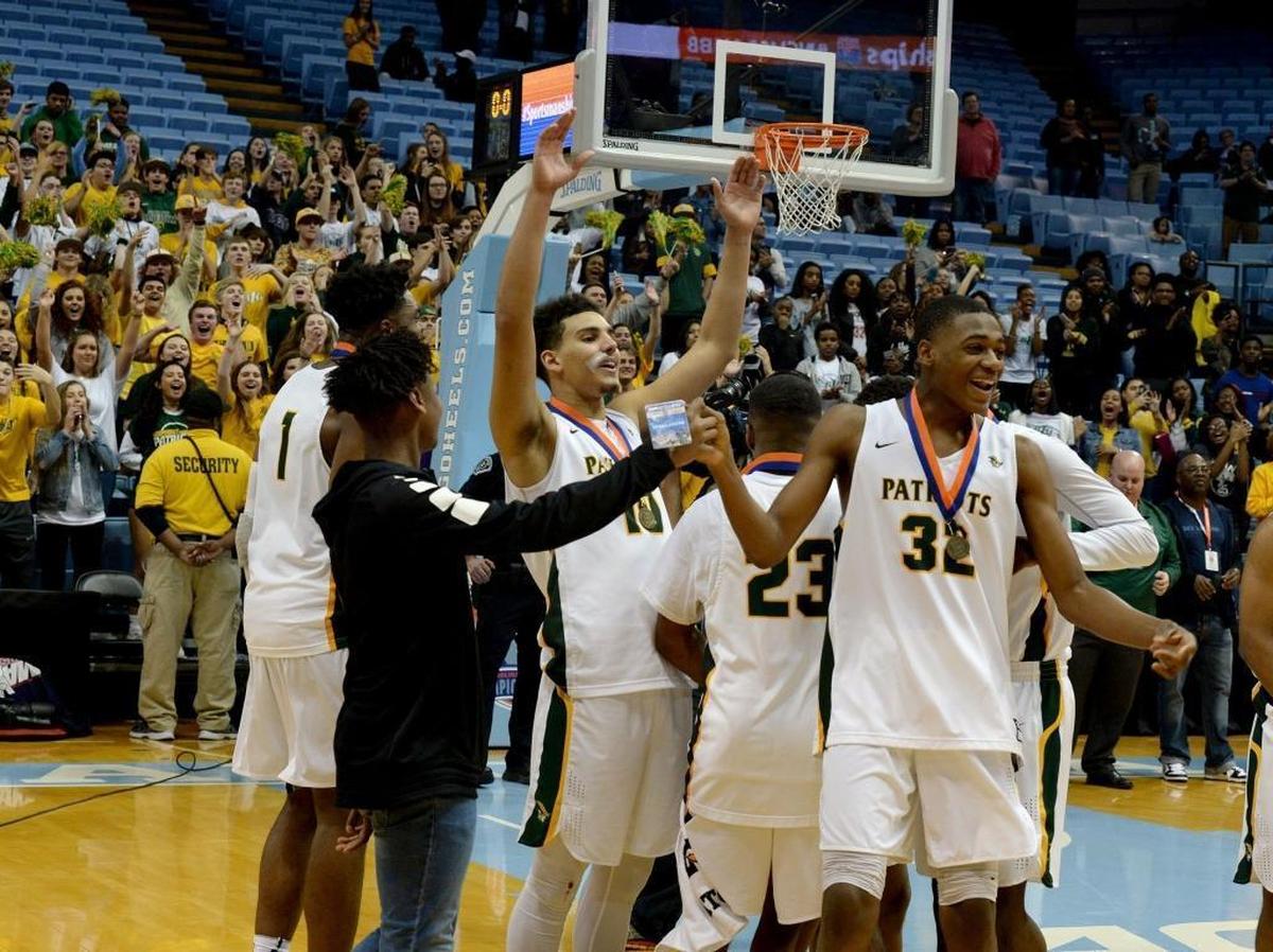 Independence players celebrate winning the state championship over Heritage after Saturday evening's NCHSAA state basketball championship 4A game between Independence and Wake Forest Heritage at the Smith Center in Chapel Hill.