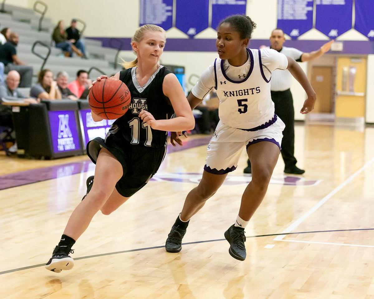 Hough point guard Caroline Swartz (11) drives the lane against Ardrey Kell’s Kennedy Cash during the schools’ game Tuesday, Nov 27, 2018