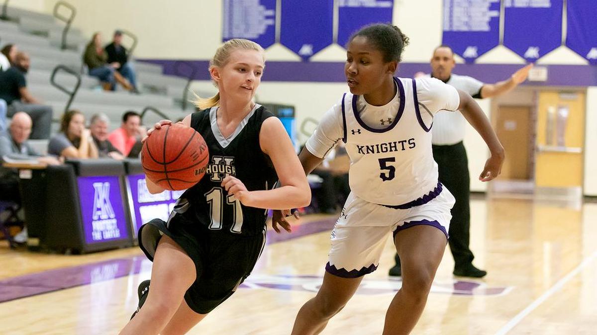 Hough point guard Caroline Swartz (11) drives the lane against Ardrey Kell’s Kennedy Cash during the schools’ game Tuesday, Nov 27, 2018