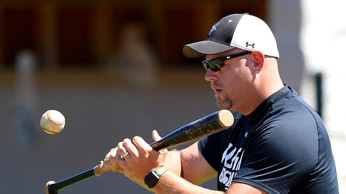 Hough High head coach Jimmy Cochran hits a bunt back to the pitcher during practice on Monday, May 8, 2017.