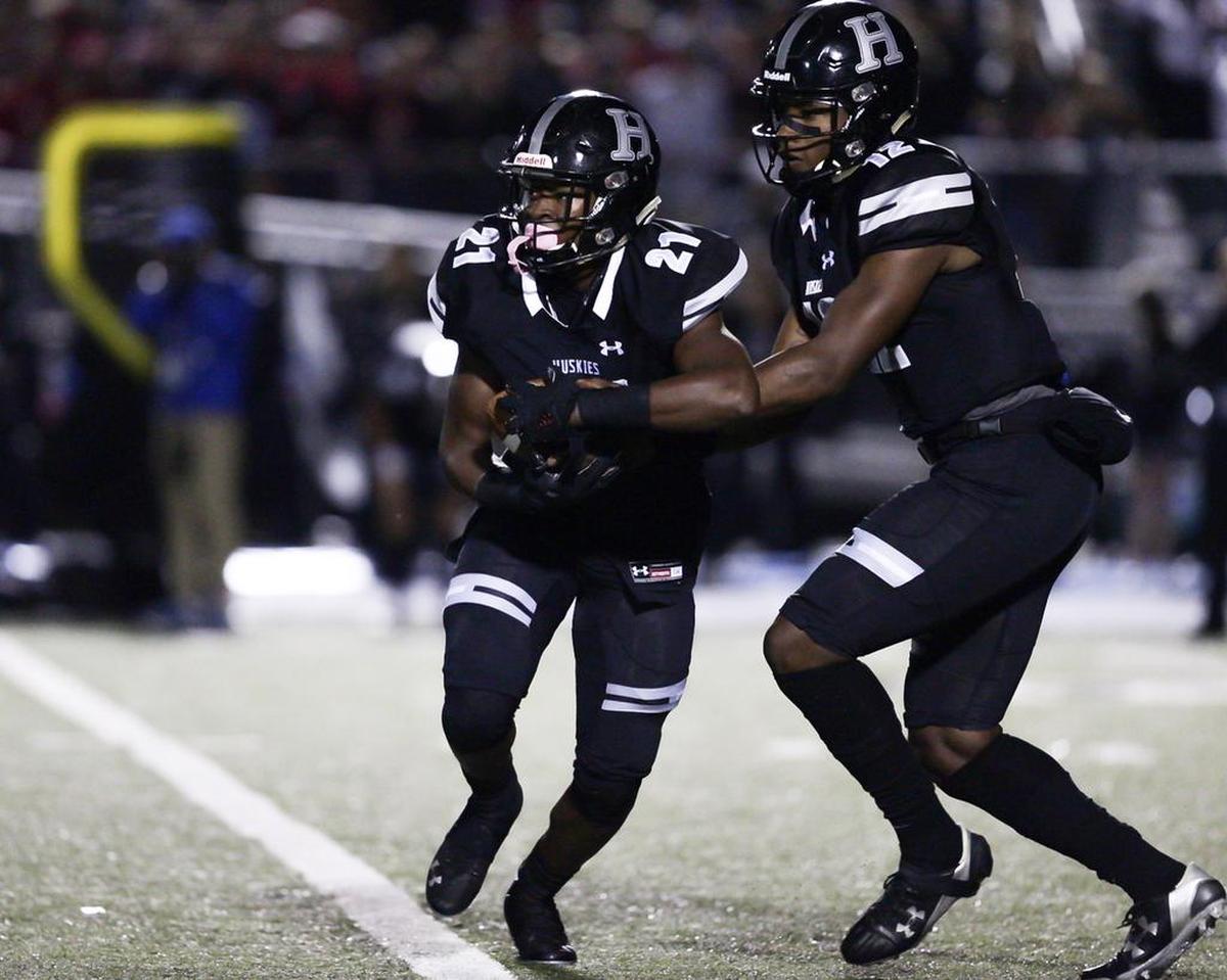Hough running back Evan Pryor (21) takes the hand off from QB Kennique Bonner-Steward in Friday’s game with Mallard Creek.