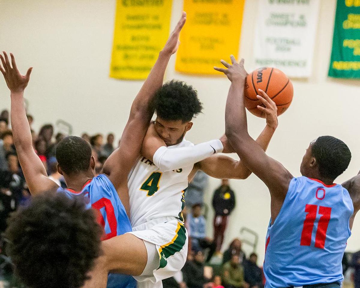 Independence High’s Raja Milton tries to make a pass through defense against Olympic.