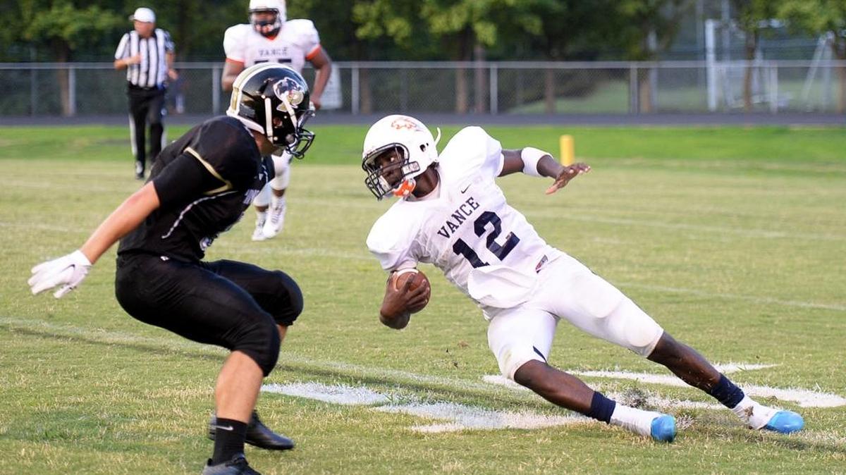 
Vance quarterback Kingsley Ifedi (12), right, tries to turn the corner on Providence defender Connor Johnson during last week’s Vance - Providence football game.
