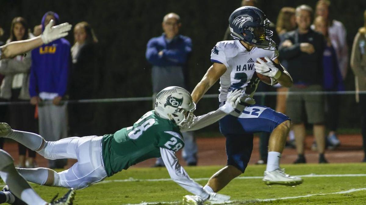A Charlotte Latin receiver pulls away from a Charlotte Country Day defender. The two Charlotte rivals are among Mecklenburg County private schools in The Observer’s 2024 preview
