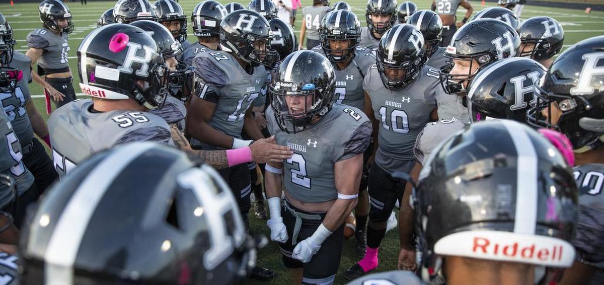 Hough’s Will Fording (2) gets his teammates pumped up before Friday’s 42-27 win over North Meck.
