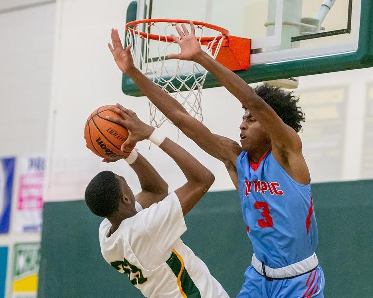 Olympic's Josh Banks (3) gets the block during late second quarter action at Independence