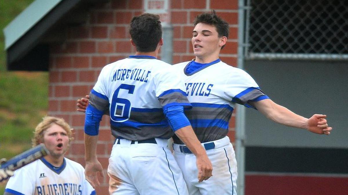 Booresville's Sam Iler, left and teammate Nick DaCosta, right, celebrate Iler's scoring a run against Butler during second round action of the NCHSAA 4A West Division round of 32 play on Thursday, May 11, 2017.