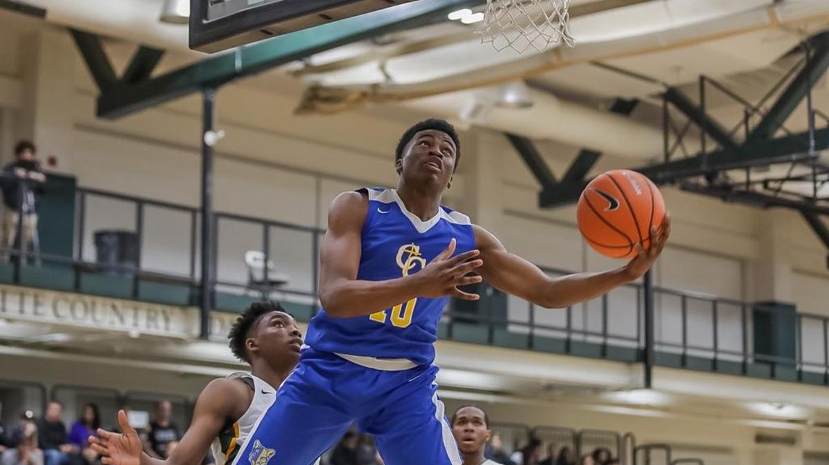 Carmel Christian junior Donovan Gregory (10) drives the baseline and finishes the layout during 1st quarter action. BSN Queen City Clash Women's Final December 23, 2017.