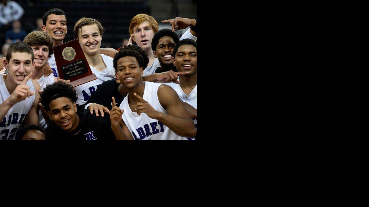 
Ardrey Kell's Steven Santa-Ana, holding trophy, and his teammates pose with the regional championship trophy after he hit the game-winning 3-point shot in the closing seconds against West Charlotte. Ardrey Kell defeated West Charlotte 52-50 to win the NCHSAA 4A boys regional championship game at Lawrence Joel Veterans Memorial Coliseum in Winston-Salem, March 7, 2015.
