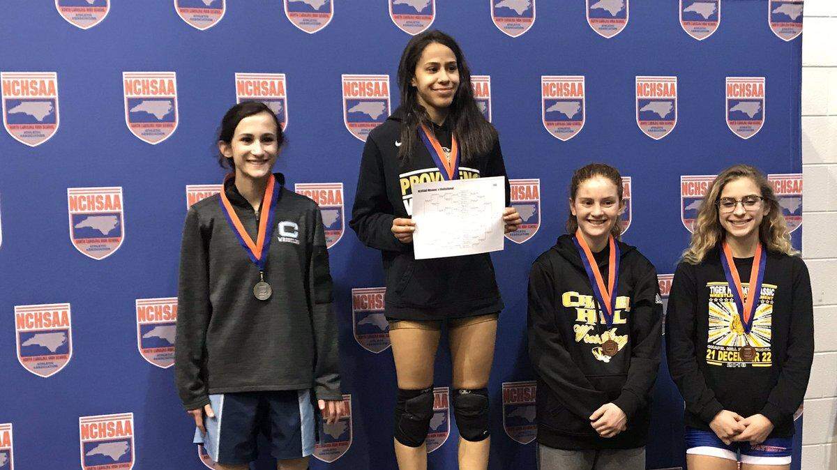 Providence High 106-pound wrestler Nikoly Dos Santos (center) won the first NCHSAA girls wrestling individual state championship Saturday.