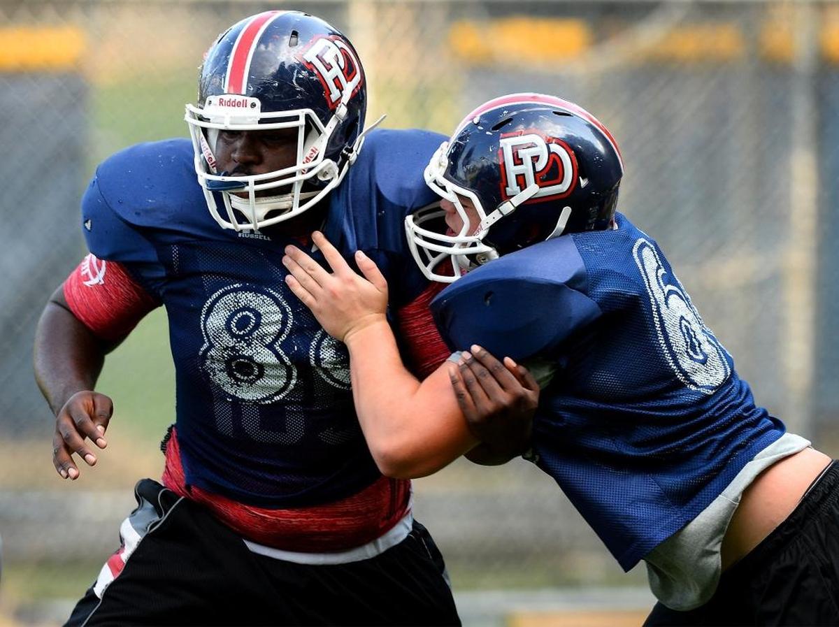 Providence Day defensive tackle Elijiah Brown, left, during practice on Tuesday.