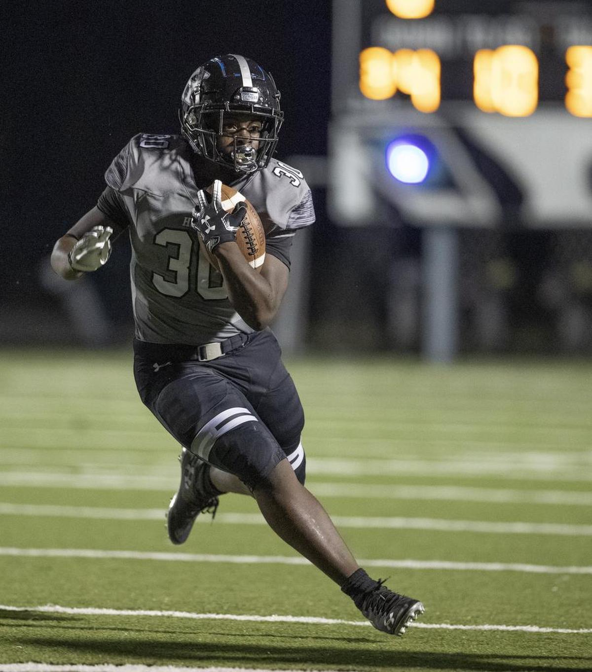 Hough ball carrier Kwesi Kyei-Fordjour (30) looks for running room against visting North Mecklenburg on Friday.