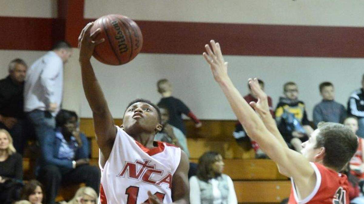 Northside Christian Academy's Michael Mckoy carries the ball to the basket during Tuesday night's game played at Northside Christian on Jan. 26, 2016.