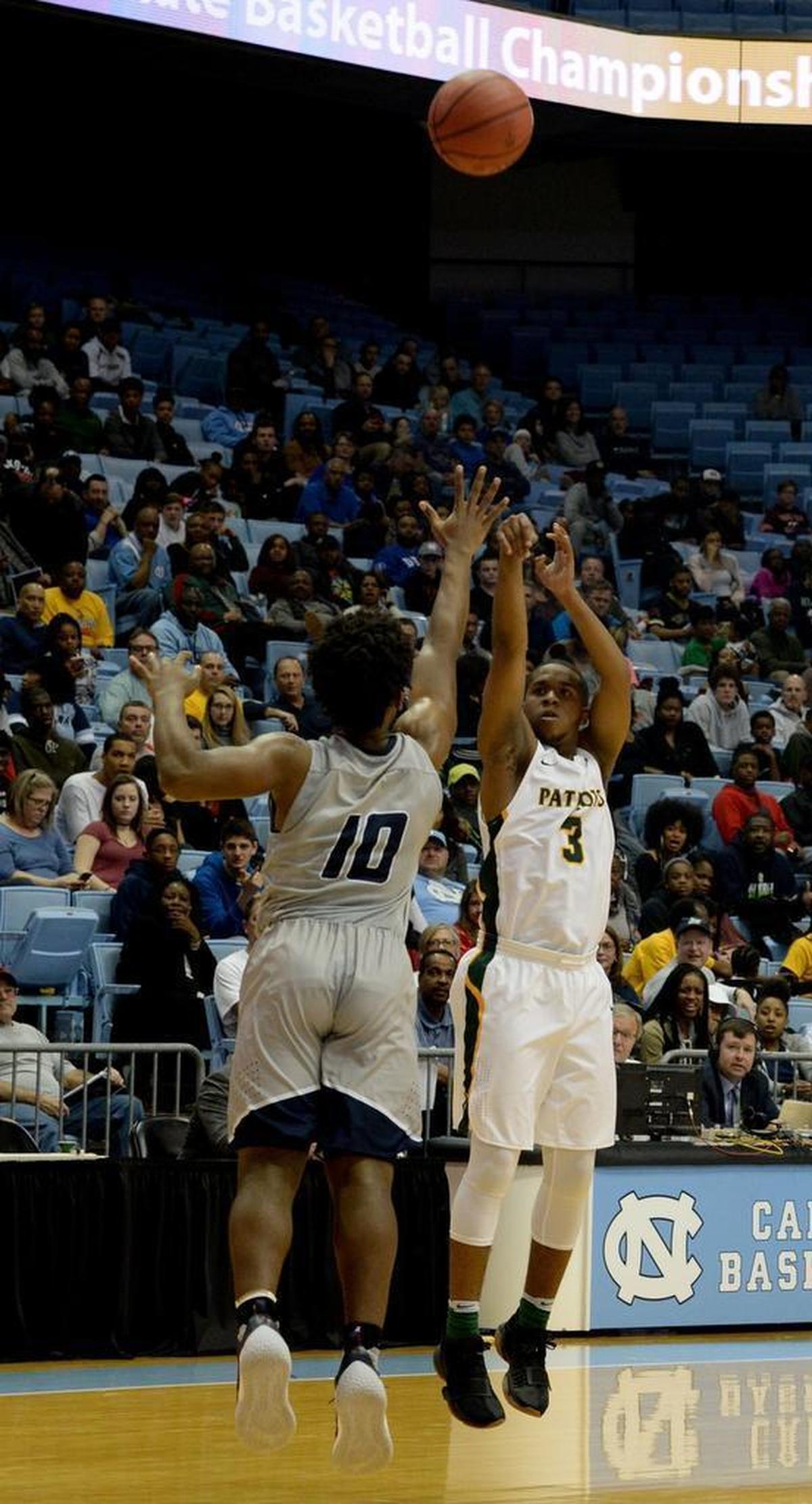 Independence # 3Jordan Mobley shoots against Heritage #10 Tre Waller during Saturday evening's NCHSAA state basketball championship 4A game between Independence and Wake Forest Heritage at the Smith Center in Chapel Hill.