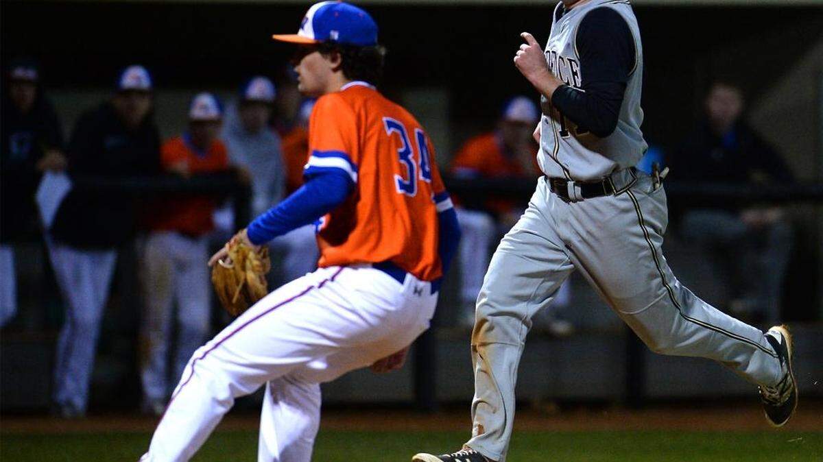 Providence’s Tucker Jones, right, scores a run as Marvin Ridge pitcher Zach Zdimal looks to cover home plate after a wild pitch Friday night. Providence defeated Marvin Ridge 2-0.