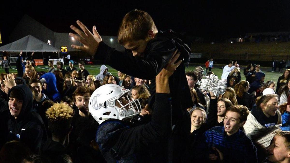 Charlotte Christian quarterback Garrett Shrader, center, celebrates his team’s 47-21 win against Providence Day in Friday’s NCISAA football championship game.