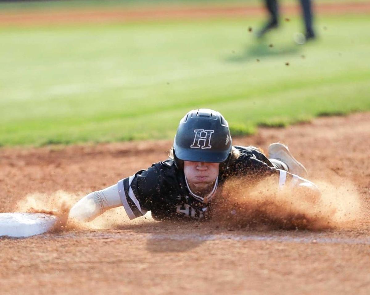 Hough Huskie short stop Jon Schuldt (2) slides into 1st base after an attempted steal. Hough would face the number 1 seed Lake Norman Wildcats in the 4A I-Meck Tournament Championship.