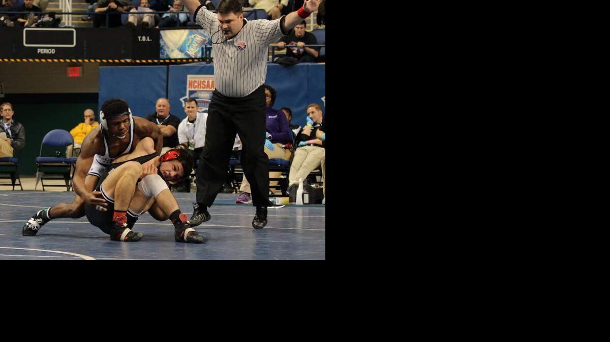 
Hickory Ridge senior wrestler Ethan Jones, top, used a late takedown to win the 160-pound 3A state title. It’s the third straight year a Hickory Ridge wrestler has won an individual championship.
