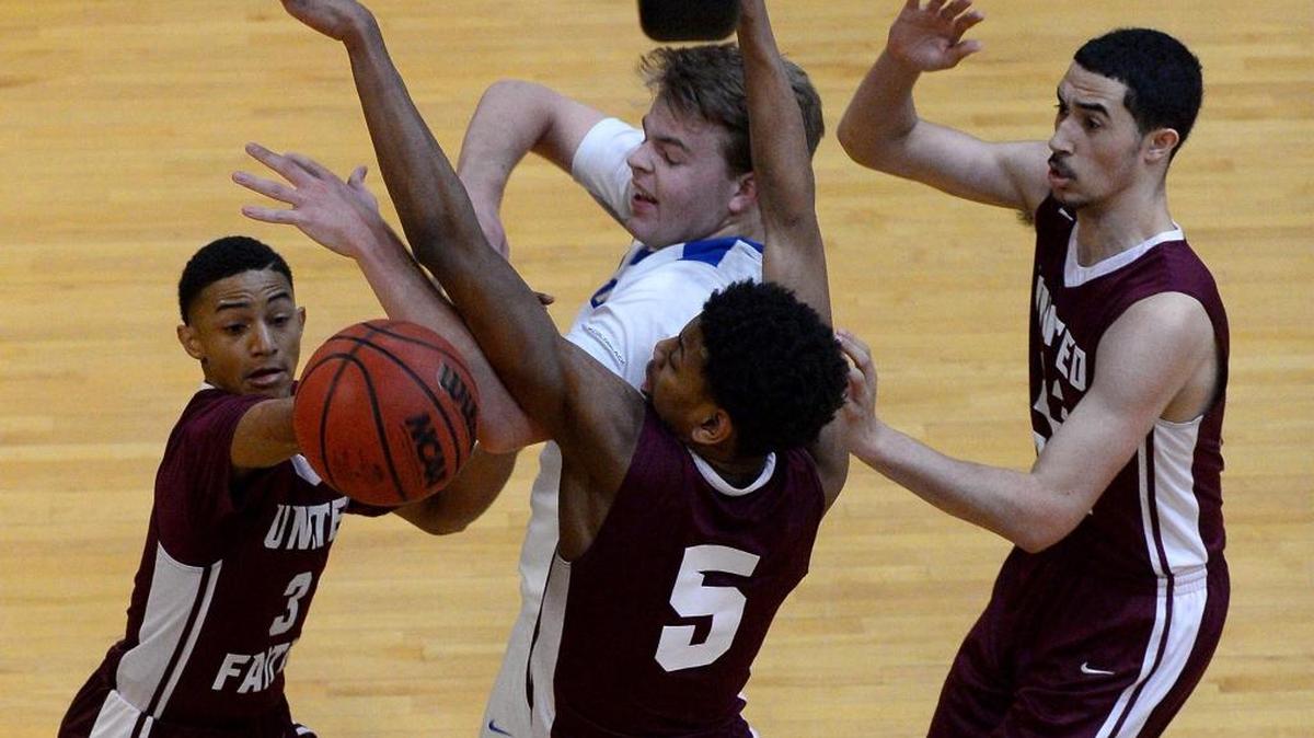 Carmel Christian's Ford Cooper, center/top of frame, fights to regain control of the ball United Faith Christian Academy's (L-R) Rafael Jenkins, Jason Thompson and KC Hankton during second half action at Carmel Christian on Friday, December 16, 2016. Carmel Christian defeated UFCA 66-63.
