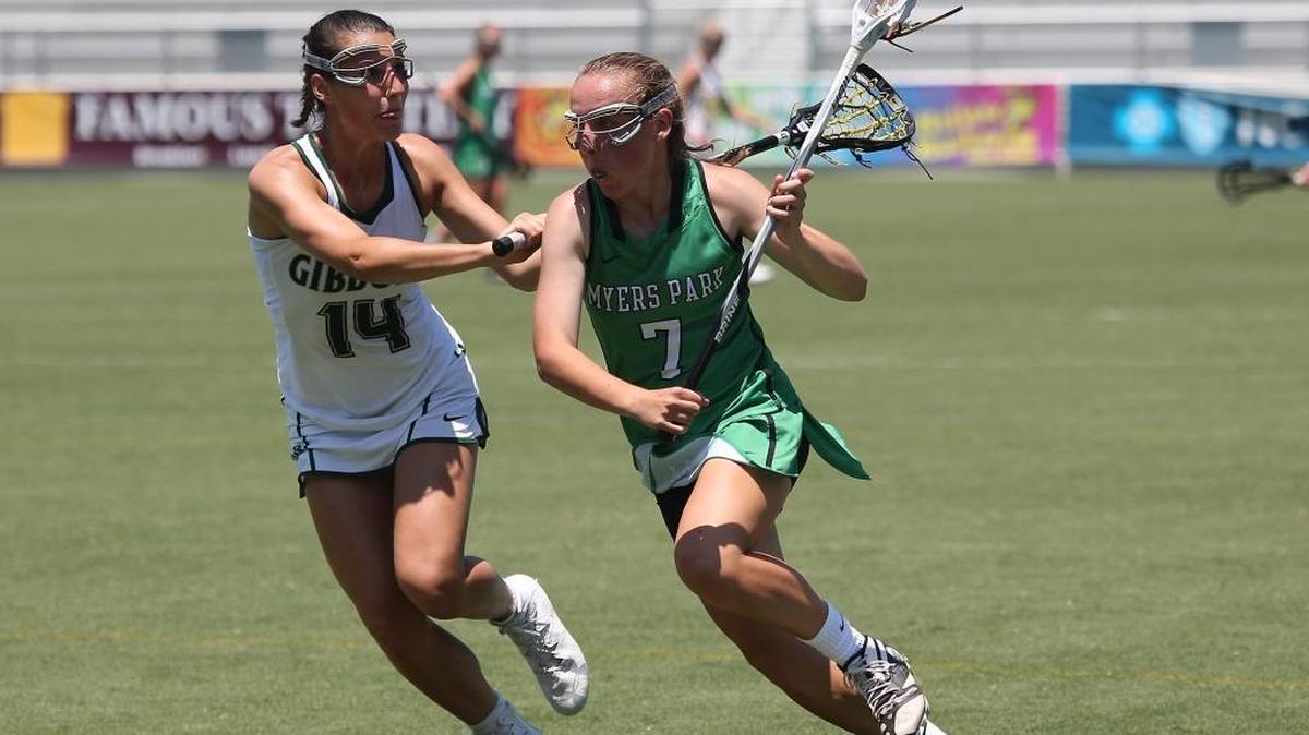Cardinal Gibbon's Sarah Boney (14) defends Myers Park's Landon Shelley (7) during the Cardinal Gibbons Crusaders high school Lacrosse match with Myers Park Mustangs high school in the State Championship 4A-game in Cary N.C. on May 20, 2017. Cardinal Gibbons won the game 19-12.