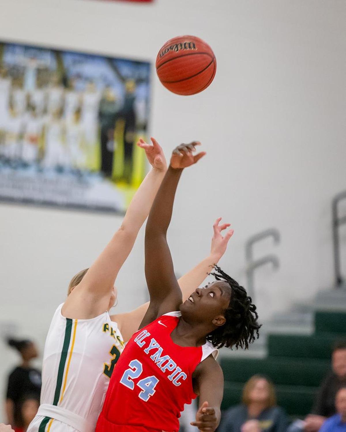 Players from Olympic and Independence (white) battle for the opening tip Tuesday.