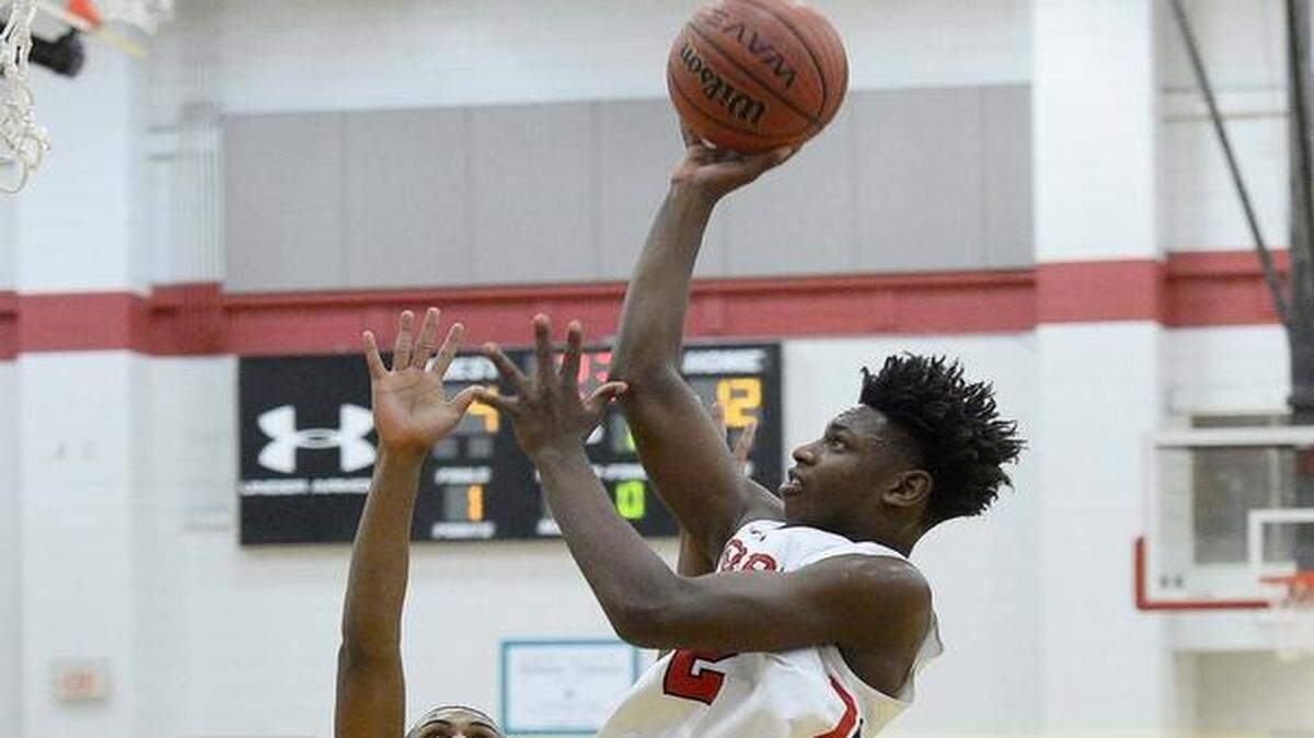 Phillip O. Berry's Jamrius Burton on right, shoots the ball over Ardrey Kell's Kam Flynn on left, during Tuesday night's game played at Phillip O. Berry Academy of Technology Jan. 05, 2016.