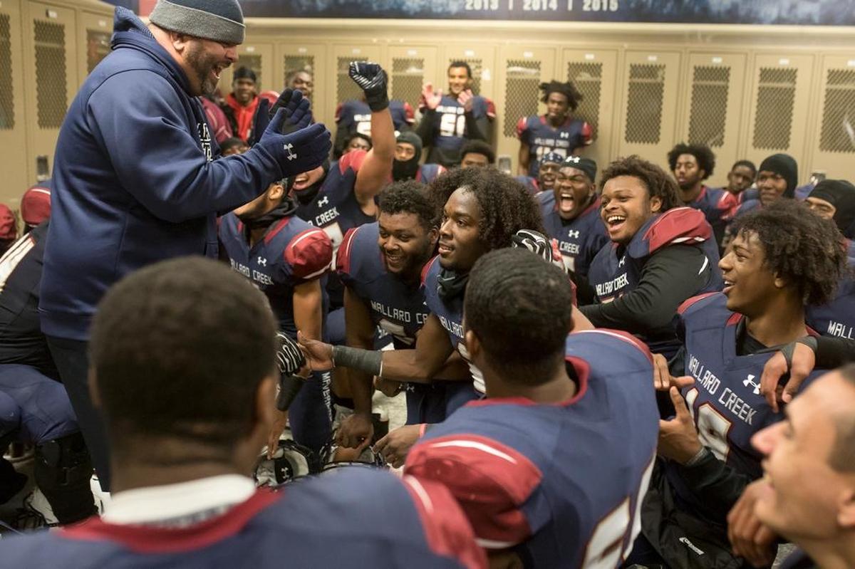 Mallard Creek coach Mike Palmieri celebrates his team’s 9-5 win over Greensboro Page in the locker room on Friday.
