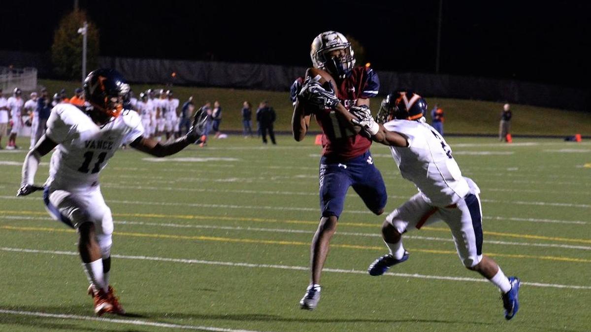 Mallard Creek #15 Tre' Exume catches a pass to score Mallard Creek's first touchdown against Vance defenders in a Vance win last month. Both teams are off this week and begin play in the NCHSAA playoffs Nov. 18
