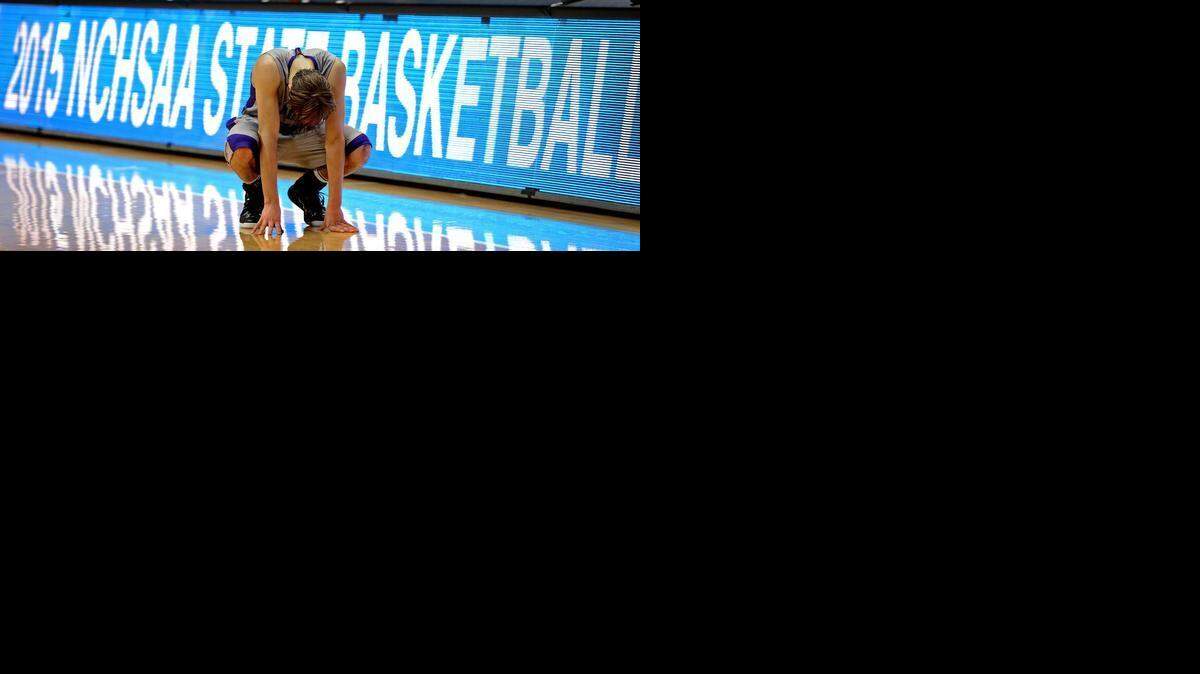 
Ardrey Kell’s Steven Santa Ana crouches down to the floor in the final moments of action vs Garner in the NCHSAA 4A Boys Championship game at the Dean E. Smith Center in Chapel Hill, NC on  March 14. Garner defeated Ardrey Kell 70-64.
