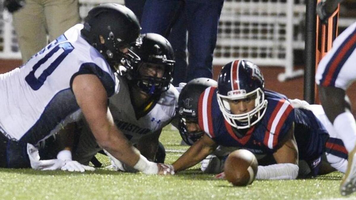 Providence Day and Charlotte Christian players scramble for a fumble during the first half of Friday’s game.