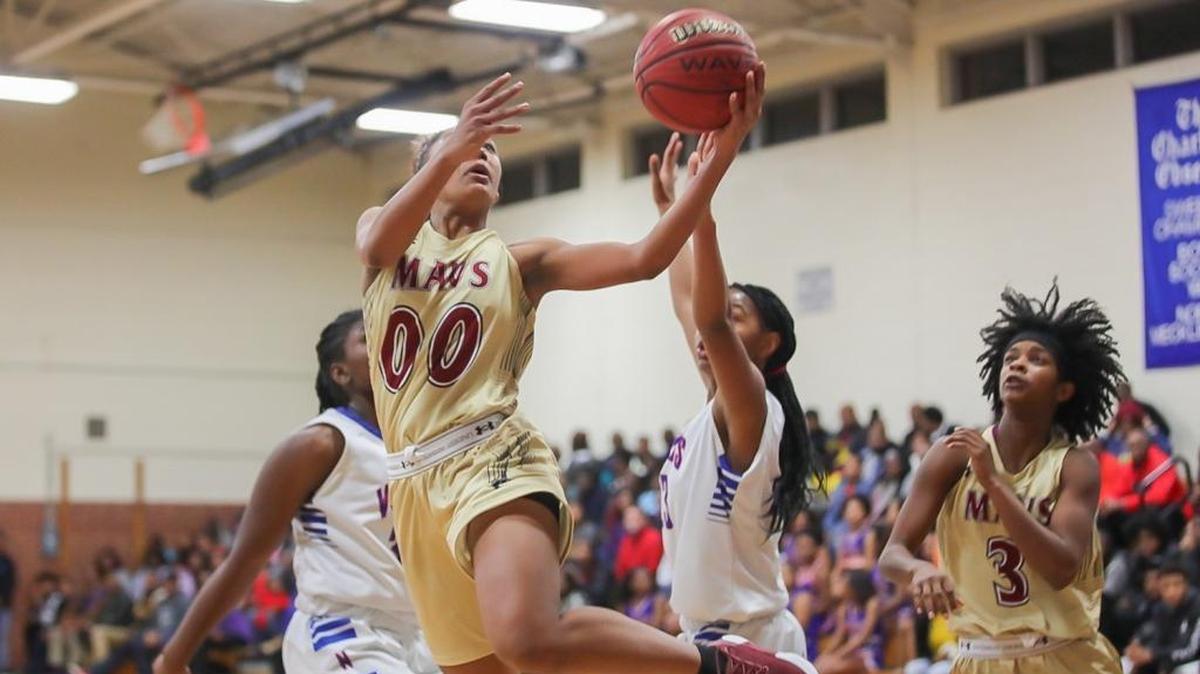 Ahlana Smith (00) of Mallard Creek drives the lane and lays completes a layup during early first-quarter action. North Meck hosted Mallard Creek on Friday, Jan. 5, 2018.