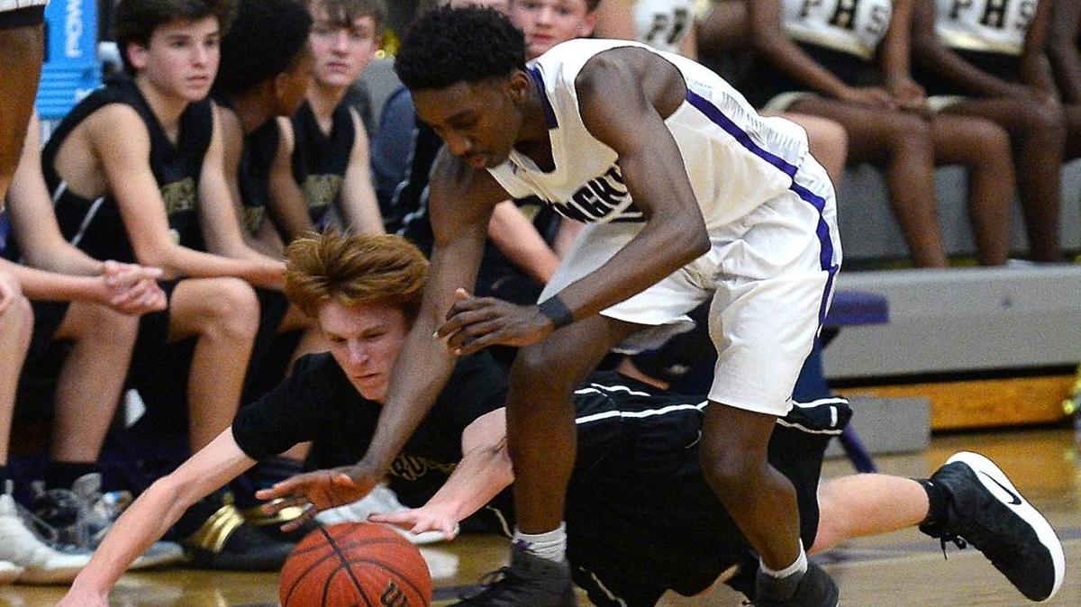 Ardrey Kell’s David Kasanganay, right and Providence's Will Cotton fight for control of a loose ball during Tuesday’s high school basketball game at Ardrey Kell. The Knights defeated the Panthers 62-30. For coverage of Tuesday’s games go to charlotteobserver.com.