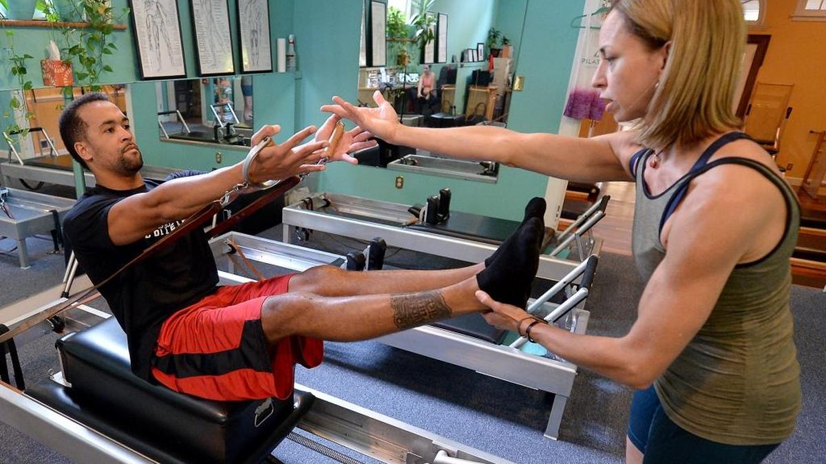 Olympic swimmer Roy Burch, seen doing rehab, is the new head swimming coach at Lake Norman Charter.