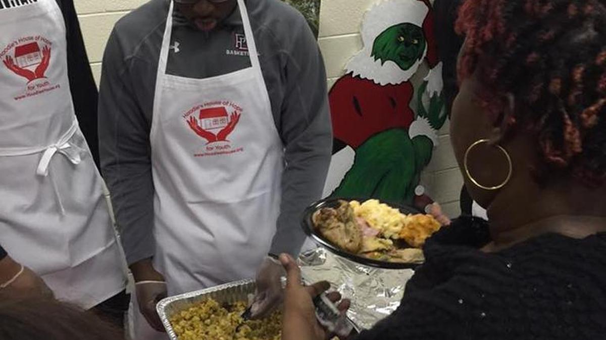 Providence Day sophomore forward Elijiah Brown participates in Sunday’s community feeding event sponsored by Hoodies House of Hope