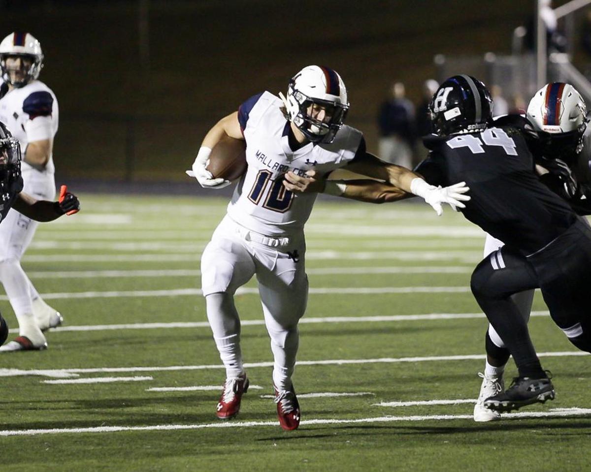 Mallard Creeks’ Nick Treco (10) breaks through the defense for the game-sealing touchdown Friday in a 26-10 win at Hough.
