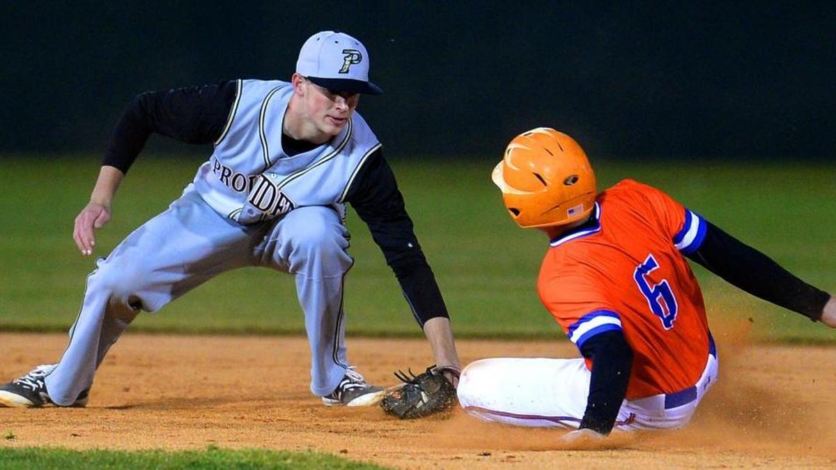 Providence High's Logan Davidson, left, applies the tag to Marvin Ridge Mark Glover, right, at second base during prep baseball action on Friday, March 4, 2016 at Marvin Ridge High School. Providence defeated Marvin Ridge 2-0.