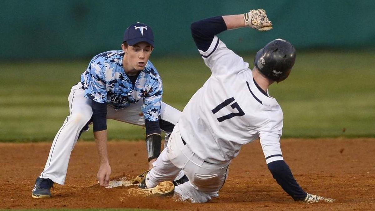 Hopewell’s Michael Chain tags Charlotte Latin's Britt Fuller out at second base during the Jack Sink Easter baseball tournament played at Myers Park high school Tuesday.