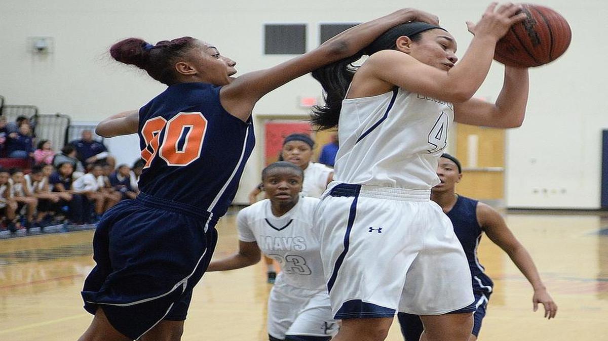 Mallard Creek Mavericks girls varsity play Vance Cougars in a prep basketball game at Mallard Creek High last month. Vance Cougars # 00 Ahlana Smith fouls Mallard Creek Mavericks # 4 Eileen De La Cancela as she goes for the shot.