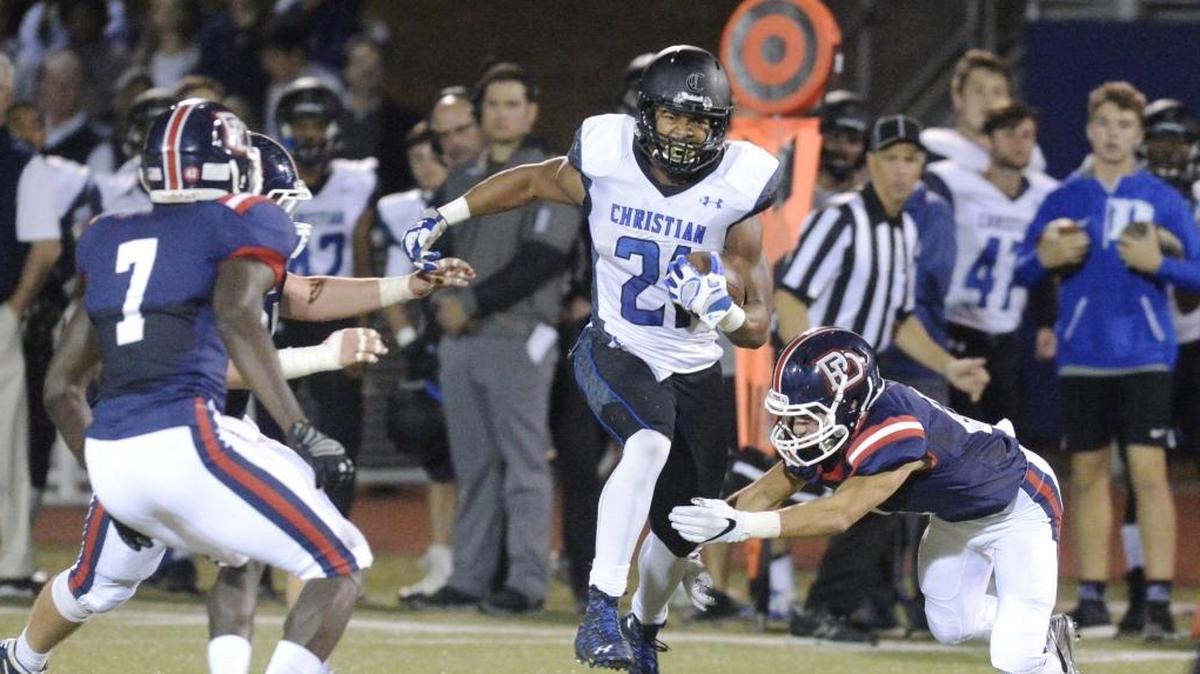 Charlotte Christian's Justus Woods (21) finds a hole in Providence Day’s defense on Friday, Oct. 27. The teams meet again for the state championship Friday.