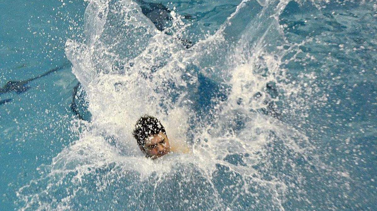 Mario Erotokritou, 17, a junior at Marvin Ridge High School enters the water during a dive in the 3A West regional championships Saturday. The NC 4A West regional swimming & NC 3A West regional diving championships were held at Huntersville Family fitness & Aquatic Center on Saturday, Feb.6, 2016.