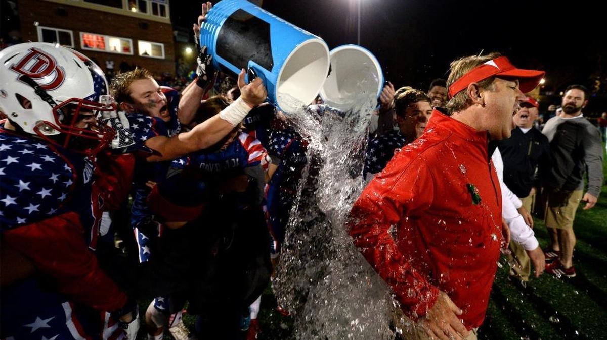 Davidson Day head coach Chad Grier, right, is soaked with water after his team beat Charlotte Latin in the 2015 NCISAA Division I state championship. Grier told the Observer Wednesday that he is resigning after six seasons.