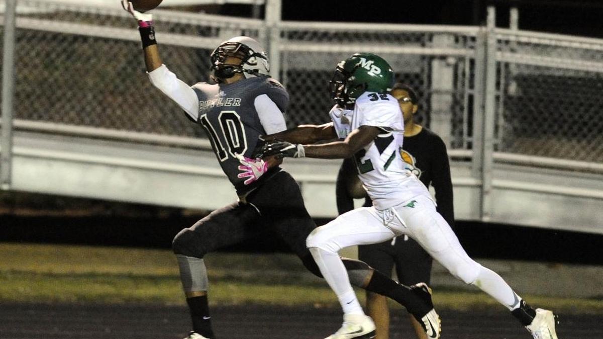 Butler's Kusegi Cureton (10) makes a one-handed catch as Myers Park's Trey Bly (32) defends during in the first half of their Southwestern 4A conference football game at Myers Park on Thursday, October 6, 2016. Butler led 31-0, at halftime.