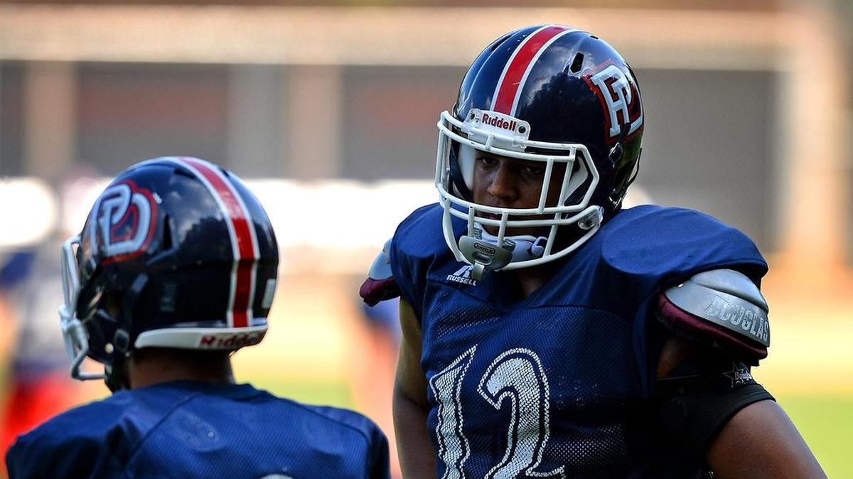 Providence Day lineman Jacolbe Cowan, right, helped the Chargers win their second straight game Friday, 67-0 at Concord Cannon