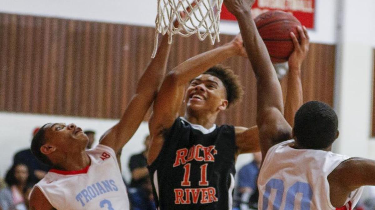 Rocky River’s Jaden Springer puts up a shot against Olympic defenders Savion Evans (3) and Jalen Barr during Tuesday night’s N.C. 4A first-round state high school basketball playoff game. Rocky River won 85-72. For scores, summaries and details of Tuesday’s games, go to charlotteobserver.com.